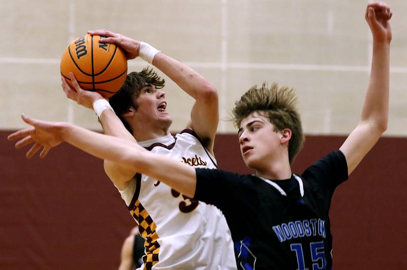Richmond-Burton's Jace Nelson shoots the ball as Woodstock's Liam Laidig three to stop the shot during a Kishwaukee River Conference basketball game on Wednesday, Feb. 5, 2025, at Richmond-Burton High School.