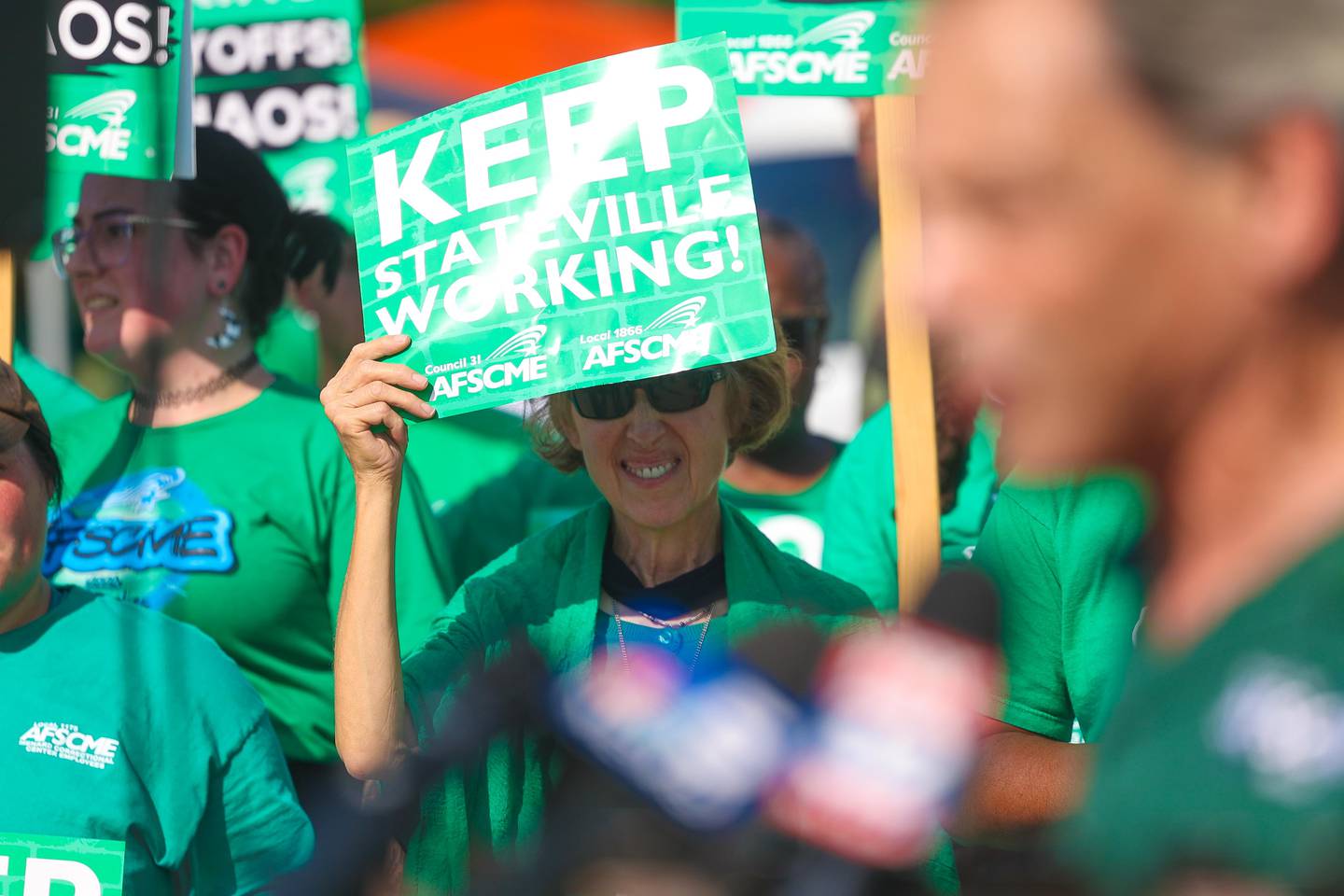 A picketer listens to AFSCME Local 31 Deputy Director Mike Newman speak at a picket gathering outside the Stateville Correctional Center on Thursday, August 29, 2024 in Joliet.