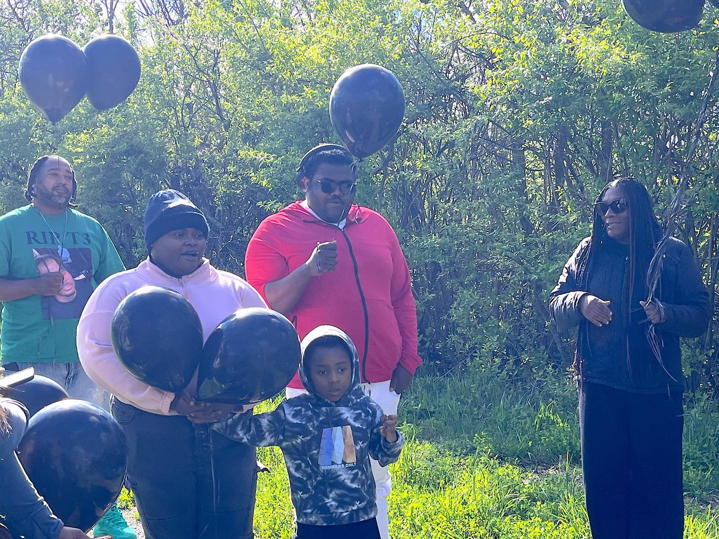Jennifer Sanders (center), the sister of Terhan Foster Gordon, 36, of Joliet, speaks at a balloon release in his memory on Saturday April 18, 2026, in Mokena.