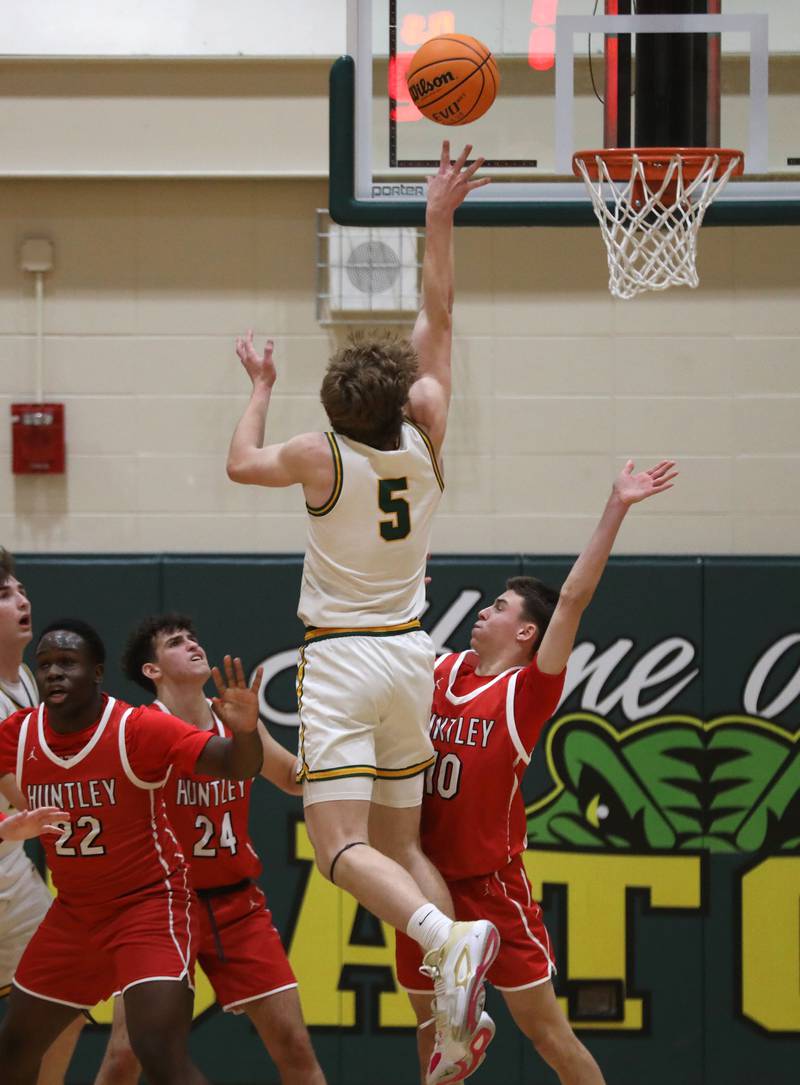 Crystal Lake South's Carson Trivellini shoots the ball over the defense of Huntley's Seun Oladipo, (left to right) Casey Kaczmarski and Brady Hassels during a Fox Valley Conference boys basketball game on Friday, Jan. 30, 2026, at Crystal Lake South High School.