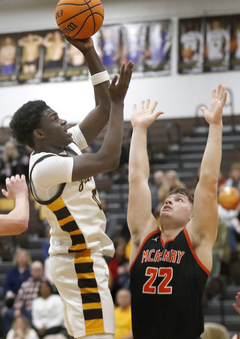 Jacobs' Samson Averehi shoots the ball over McHenry's Conner McLean during a Fox Valley Conference basketball game on Friday, Jan. 24, 2025, at Jacobs' High School.