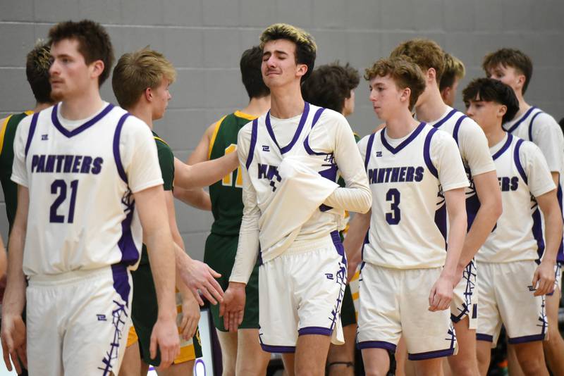 An emotional Braden Campbell of Manteno, center, fights back tears during the postgame handshake line following the Panthers' 45-37 loss to Coal City in the IHSA Class 2A Manteno Regional quarterfinals Monday, Feb. 23, 2026.