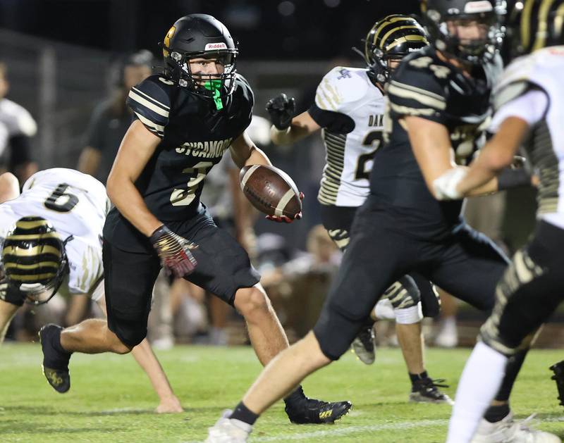 Sycamore's Kayden Galto carries the ball during their game against Oak Forest Friday Sept. 2, 2022, at Sycamore High School.