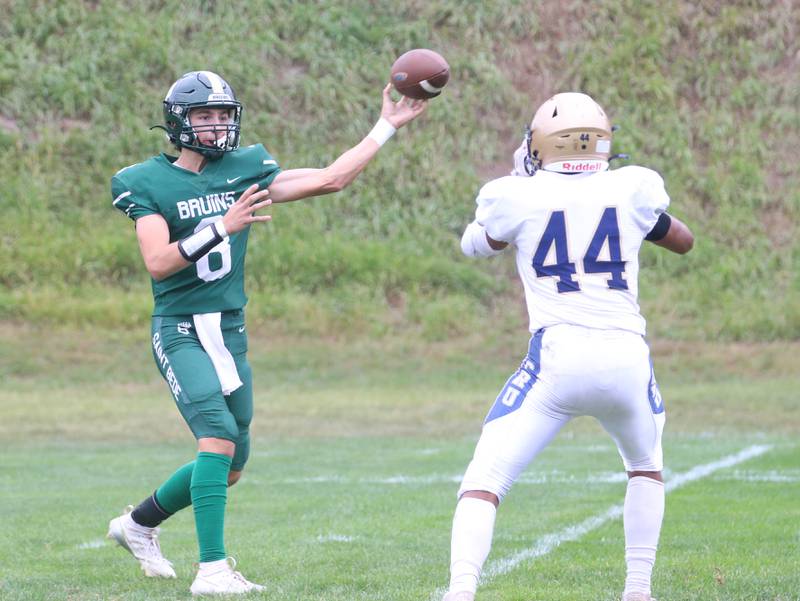 St. Bede quarterback Gino Ferrari throws a pass over the head of Marquettte's Marcus Baker during the Homecoming game on Saturday, Sept. 28, 2024 at St. Bede Academy.