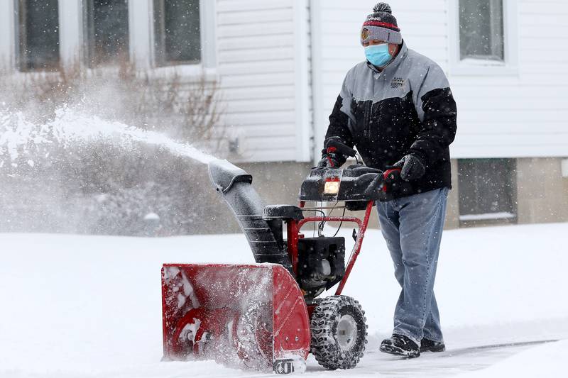 Ray Bober of Huntley uses a snowblower to clear his property on Tuesday, Jan. 26, 2021 in Huntley.
