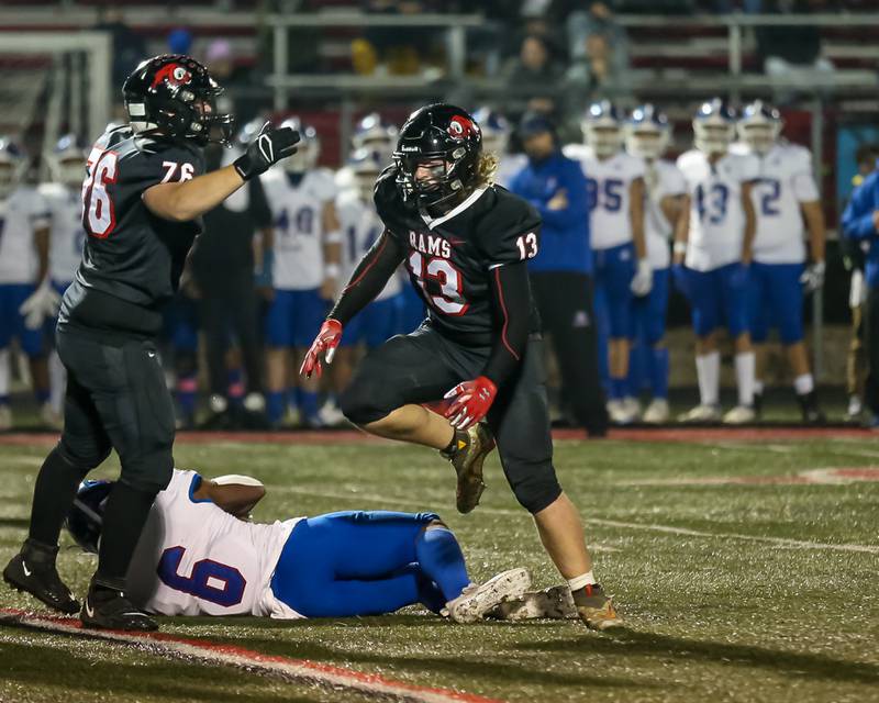 Glenbard East's Augustus Winkler (13) reacts after making a stop on Glenbard South's Carter London (6) in the backfield during football game between Glenbard South at Glenbard East.   Oct 13, 202