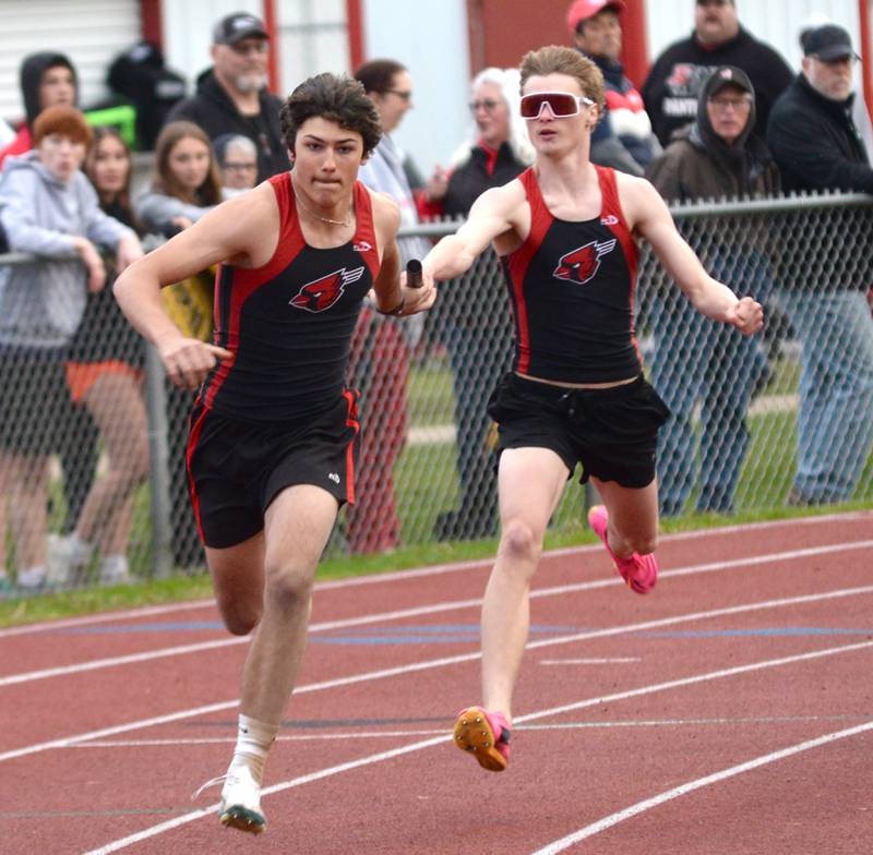Forreston's Brody Schwartz hands the baton to Jonathan Milnes in the 4x200 relay at the Hawk Classic on Friday, May 2, 2025 at Landers-Loomis Field in Oregon.