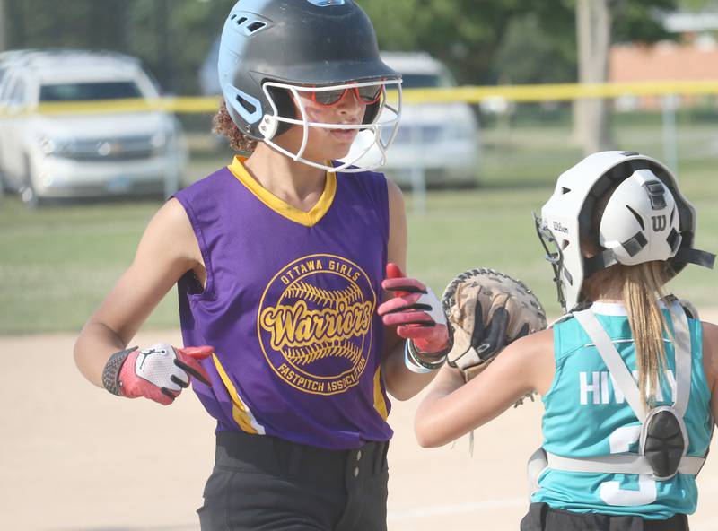 Warriors Olivia Hall-Williams scores the teams first run as Edge catcher Olivia Whitmore waits for the late throw to the plate during the Ottawa Girls Fastpitch Association 11U City Championship on Wednesday July 2, 2025 at Peck Park in Ottawa.