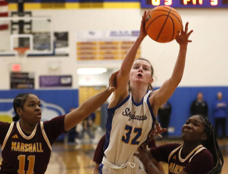 Johnsburg's Skye Toussaint grabs a rebound between Chicago Marshall's Anabel Robinson (left) and Monay Robinson (right) during a IHSA Class 2A Johnsburg Sectional girls basketball semifinal game on Tuesday, February, 24, 2026, at Johnsburg High School.