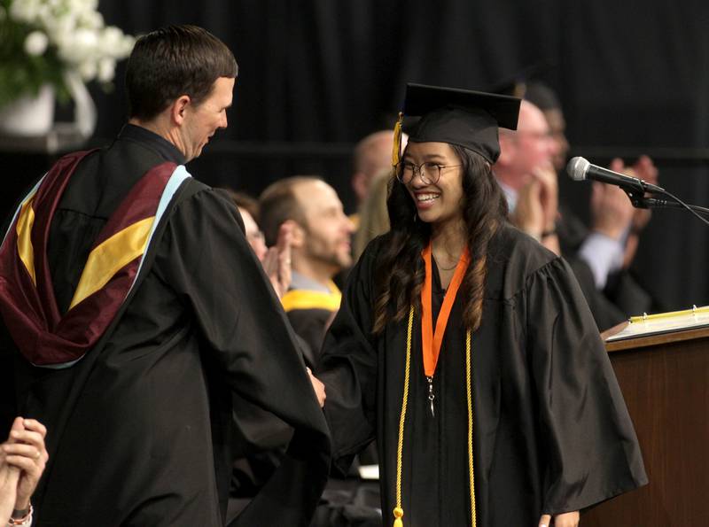 Janelle Rianne Reyes Pabona, student council executive board president, shakes Principal Jim Richter’s hand after addressing her classmates during St. Charles East’s 2023 commencement ceremony at Northern Illinois University in DeKalb on Monday, May 22, 2023.
