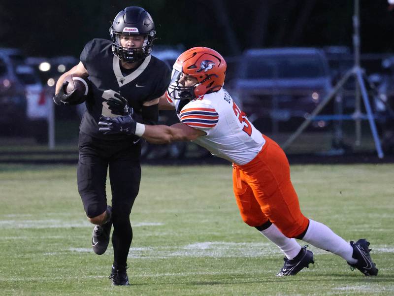 Sycamore's Luke Howieson avoids Mahomet-Seymour's Marco Casillas on a kick return during their game Friday, Sept. 12, 2025, at Sycamore High School.