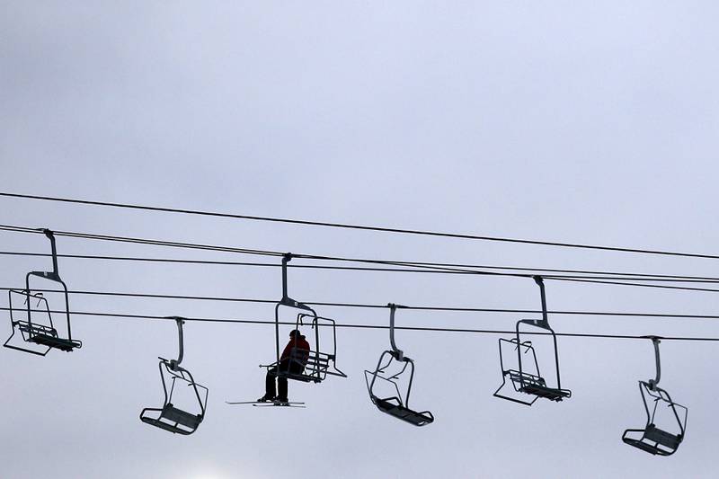 A skier rides the chair lift to the top of Wilmot Mountain Ski Resort on Thursday, Jan. 16, 2025, in Wilmot, Wisconsin.