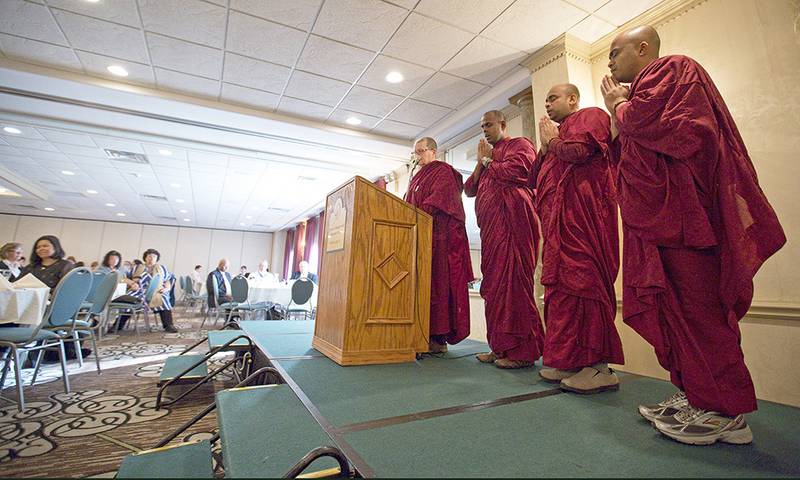 Monks from the Blue Lotus Buddhist Temple in Woodstock (L-R) BhanteSumana, Bhante Dhammadassi, Bhante Amitha and Bhikkhuni Vimala chant during a meditation session in the closing of FaithBridge's fifth annual Martin Luther King Jr. Interfaith Prayer Breakfast on Monday, Jan. 19, 2015, in Crystal Lake.