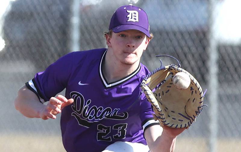 Dixon’s Quentin Seggebruch takes a throw at first base during their game against DeKalb Tuesday, March 28, 2023, at DeKalb High School.