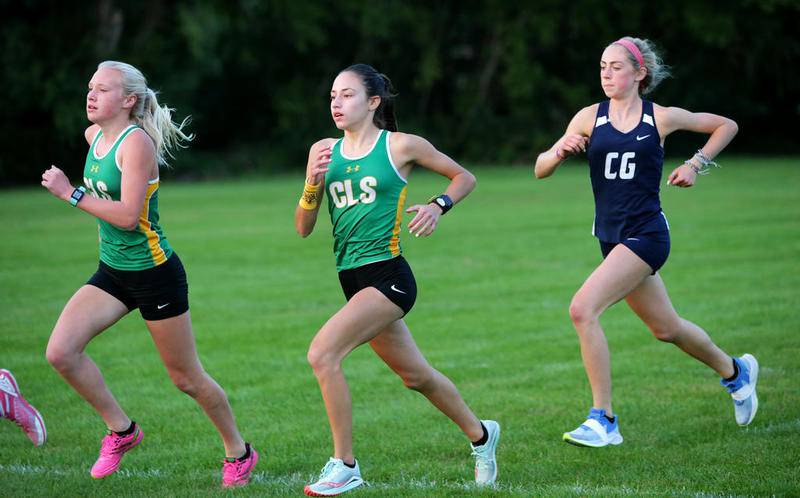 Crystal Lake South’s Abby Machesky (from left), Bella Gonzalez, and Cary-Grove’s Maggie Mason compete in a cross country meet held at Cary-Grove High School in Cary, Ill., on Tuesday, Sept. 22, 2020.