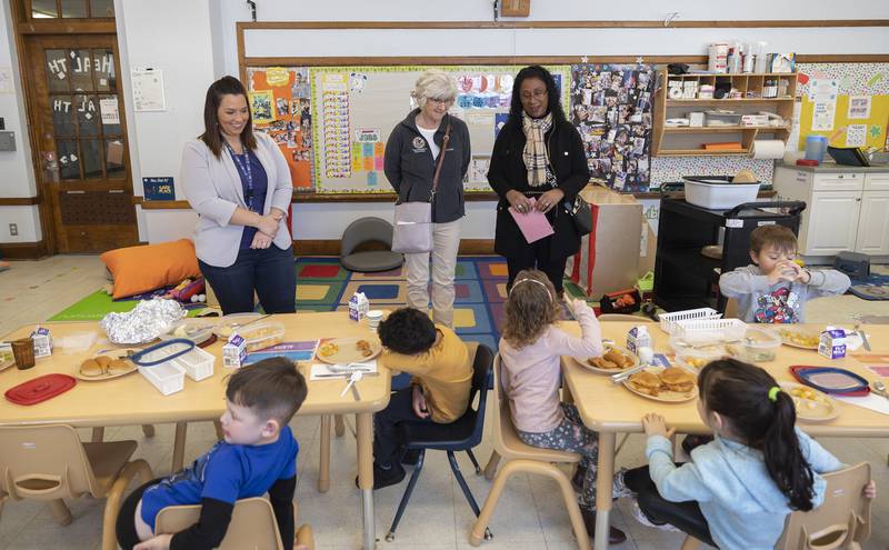 Wallace School acting director Amber Stavenger (left), Stacy Flanagan and Connie Marney speak with students Thursday, Jan. 23, 2025, during lunch hour at the Tri-County Opportunities Council Early Head Start/Head Start program in Sterling. Flanagan, filling in for State Rep. Brad Fritts and Marney, for State Rep. Tony McCombie, toured the Sterling school to learn about the workings and needs of the Head Start and Early Head Start program.