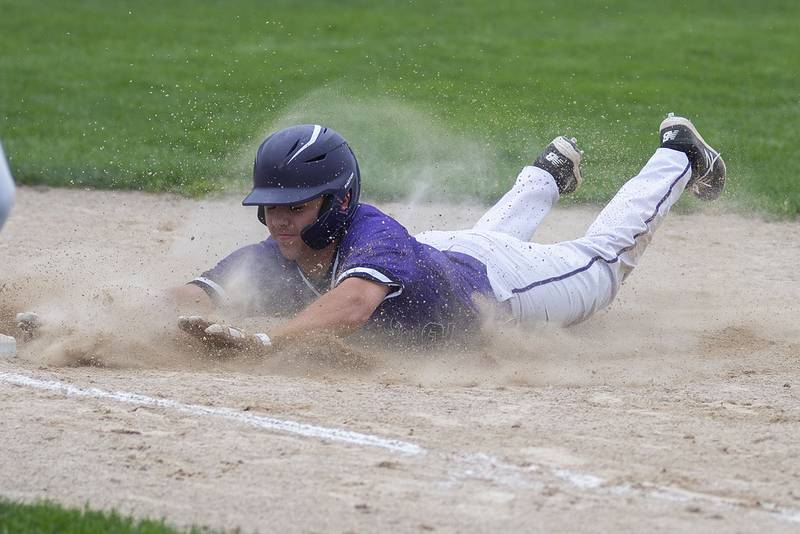 Dixon’s Trey Scheidegger slides into first but is doubled up on a caught fly Tuesday, May 17, 2022 against Sterling.
