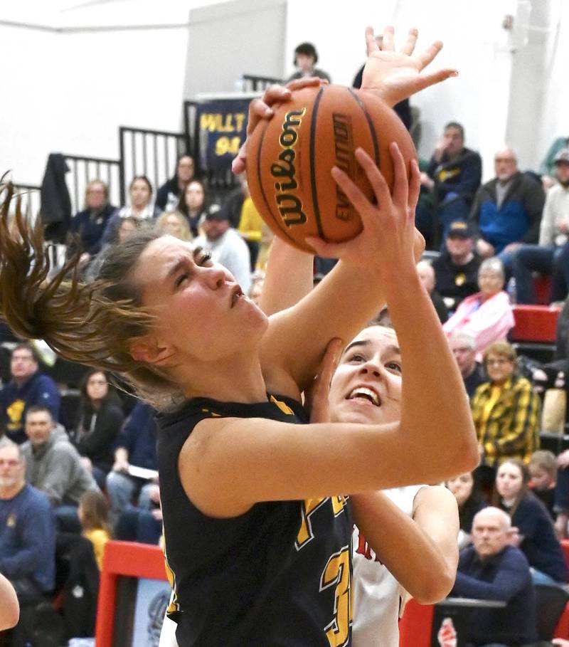 Polo's Lindee Poper (left) puts up a shot while being fouled by Amboy's Tyrah Vaessen (11) during the Class 1A Amboy Regional final Friday night.