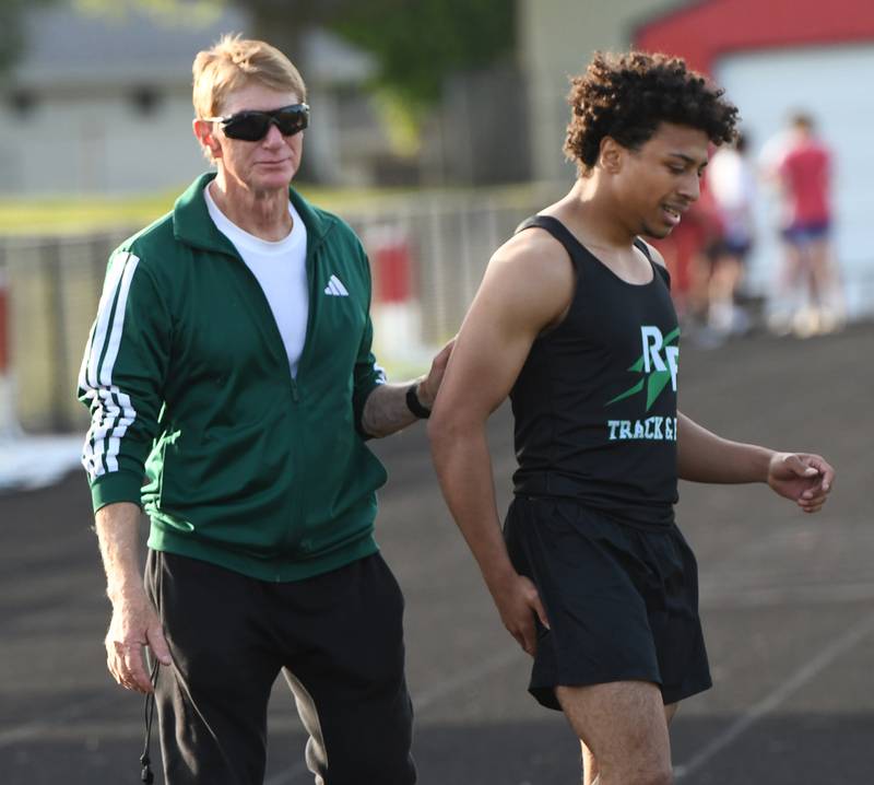 Rock Falls' Adan Oquendo is helped off the track by his coach after pulling a muscle in the finals of the 100 meters at the Big Northern Conference Meet at Stillman Valley on Thursday, May 14, 2026. Earlier in the meet, Oquendo had anchored the Rockets' 4x100 relay team to a first place finish.