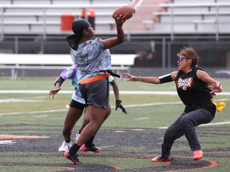 DeKalb’s Angela Gary throws a pass just before her flag is pulled Wednesday, Aug. 20, 2025, during the first practice of the DeKalb High School flag football team. The squad is preparing for their inaugural season.