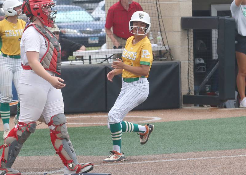 Providence Catholic's Bella Cortez reacts while scoring the teams first run against Providence Catholic during the Class 3A State finals game on Saturday, June 14, 2025 at the Louisville Slugger Sports Complex in Peoria.