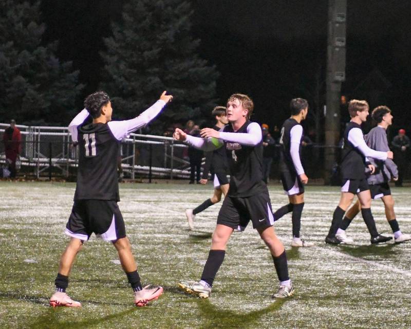 Prairie Ride teammates Anthony Castro (11) and Seth Matson (4) hug after winning the 2A super sectional soccer match on Tuesday Nov. 5, 2024, held at Wheaton Academy in West Chicago.