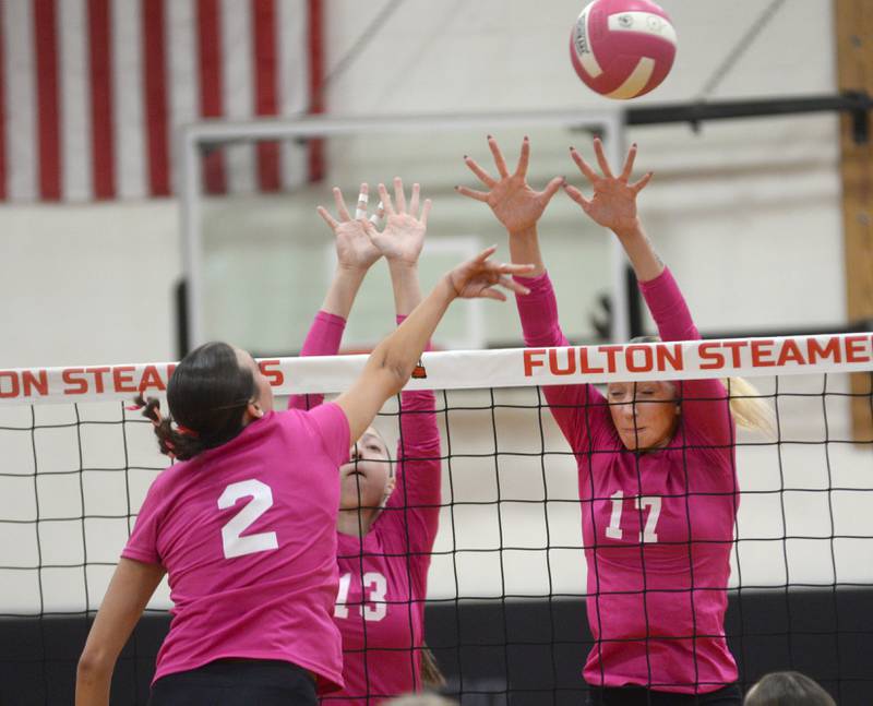 Fulton's Chloe Wilkin (2) spikes the ball as Eastland's Vanessa Allen (13) and Trixie Carroll (17) jump to block during Tuesday, Oct. 7, 2025 action in Fulton.