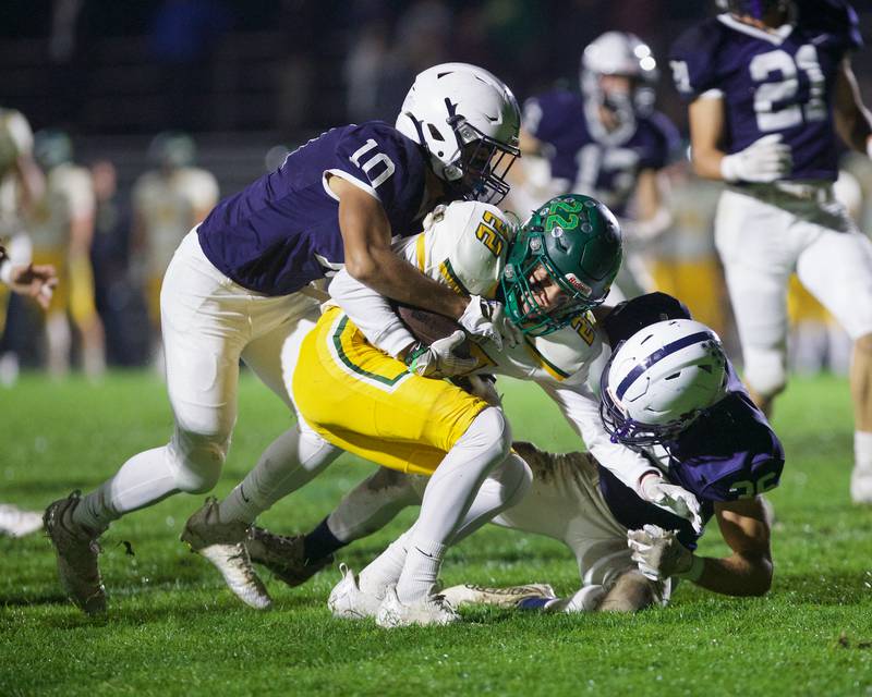 Crystal Lake South's Anthony Demirov is tackled by Gary - Grove's Thomas Battaglia (10) and Kyle Jarecki (36) 
on Friday, Oct. 13 2023 in Cary Grove.