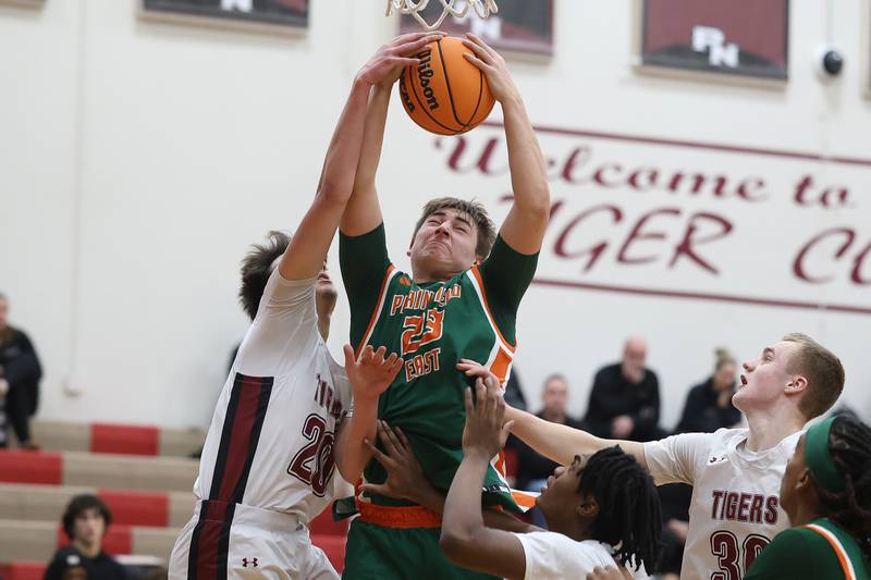 Plainfield East’s Danny Sepulveda pulls in a rebound against Plainfield North on Tuesday, Dec. 9, 2025 in Plainfield.