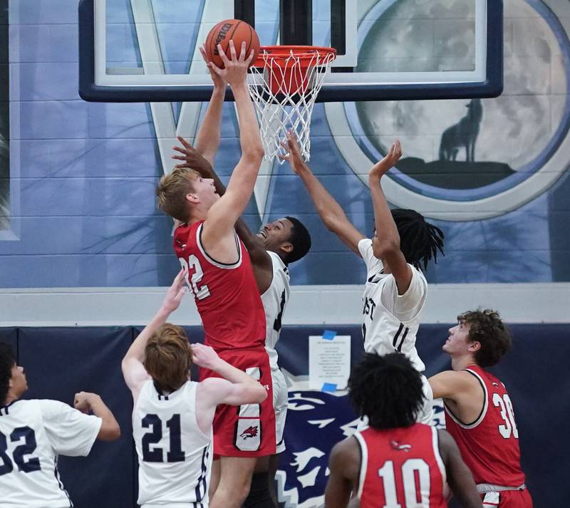 Yorkville's Jason Jakstys (32) shoots the ball in the post against Oswego East's Andrew Wiggins (1) during a basketball game at Oswego East High School on Friday, Dec 8, 2023.