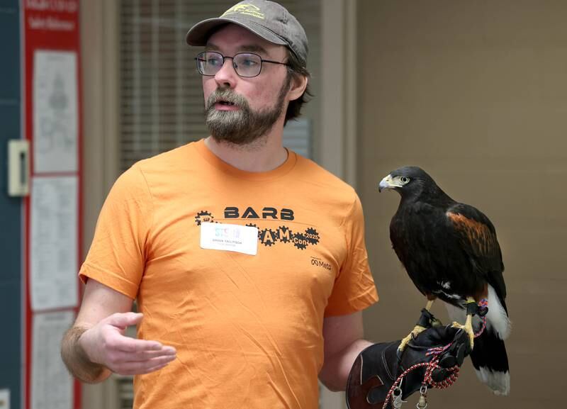 Bryan Tallitsch, District 428 IT manager, along with Soyuz, his Harris’s Hawk, talk about how technology is used in modern falconry Saturday, April 5, 2025, during Barb STEAMCon at Dekalb High School. The event featured sessions focusing on the areas of science, technology, engineering, arts and math.