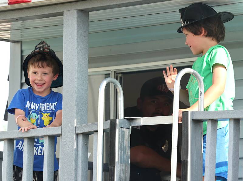 Jacoby Padilla, (left) 5, and his brother Damon, 7, from Sycamore are all smiles after escaping the DeKalb Fire Department demonstration trailer during National Night Out Tuesday, Aug. 1, 2023, in the Hy-Vee parking lot in Sycamore.
