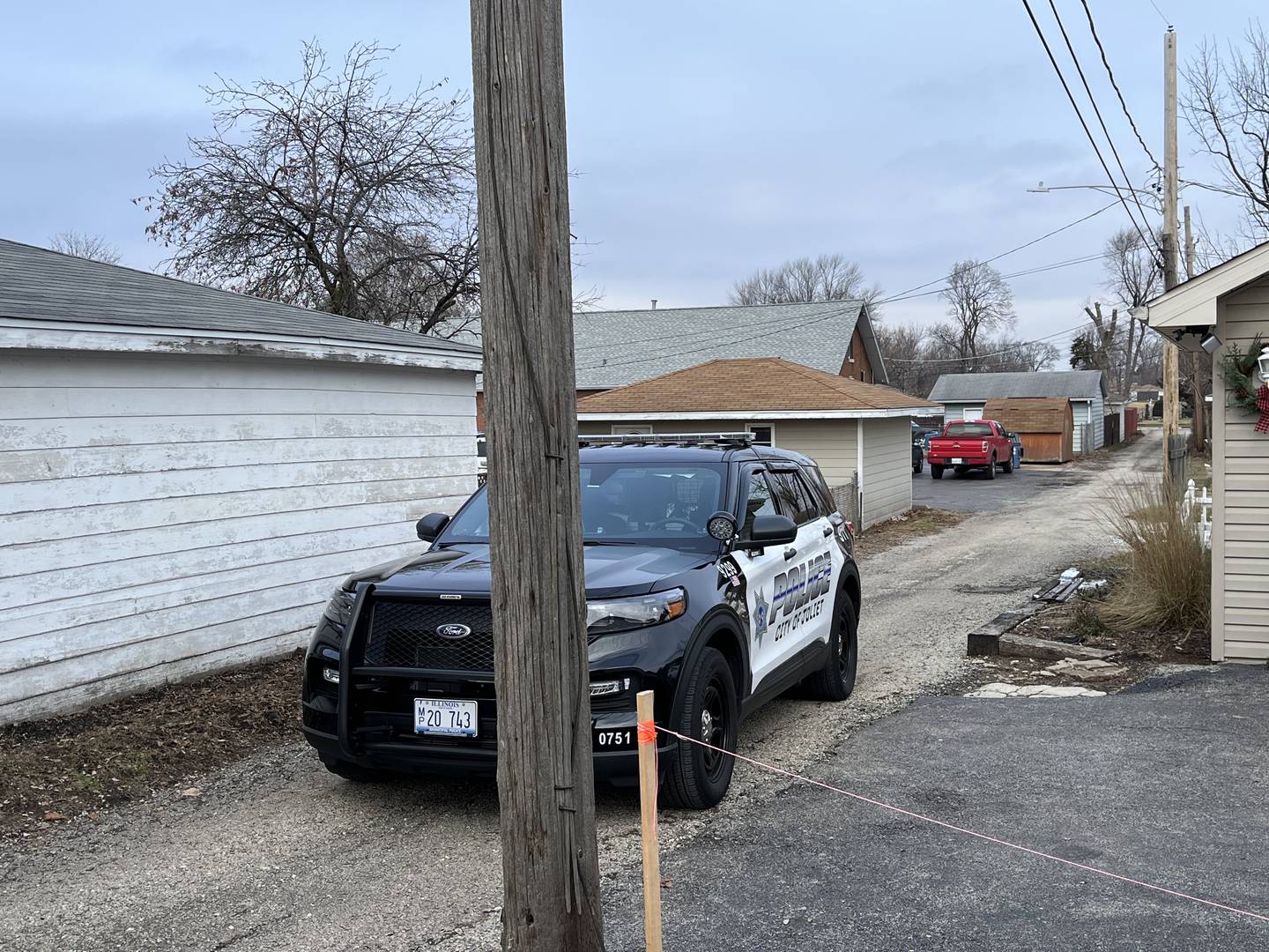 A Joliet police squad vehicle in an alley between Clement Street and Oakland Avenue. Police are investigating the fatal shooting of a 24-year-old woman on Jan. 8, 2023.