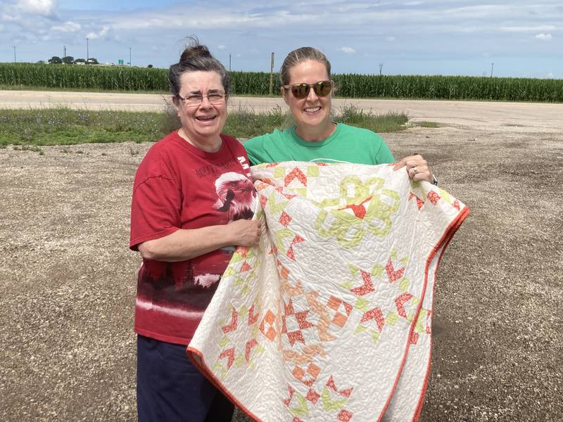 Rebekah Bierdeman, of Washburn, is pictured with quilter Pam Riss (left). Bierdeman won the quilt raffle conducted during the Streator Garden Walk.