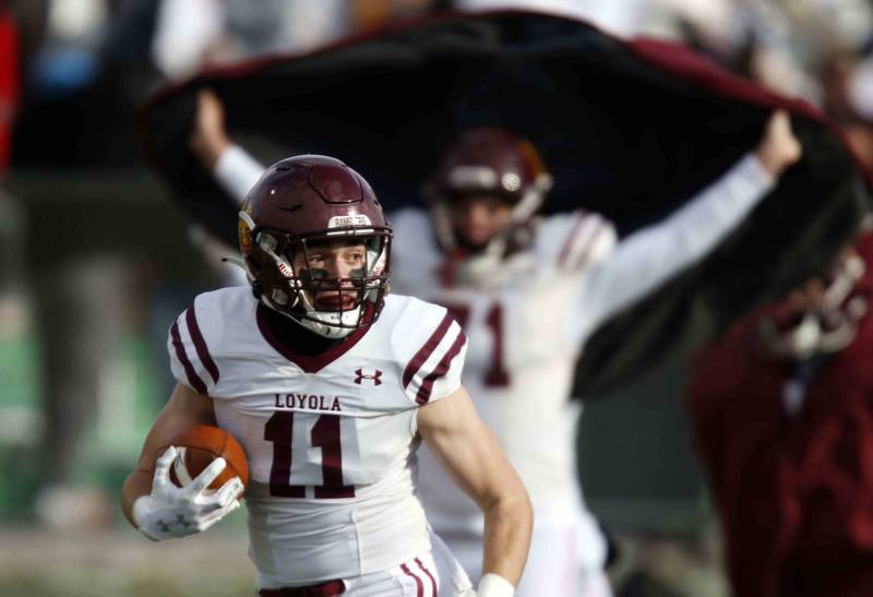 Loyola's Corey Larsen (11) looks back on his way in for a touchdown during the IHSA Class 8A semifinal football game Saturday November 19, 2022 in Elmhurst.