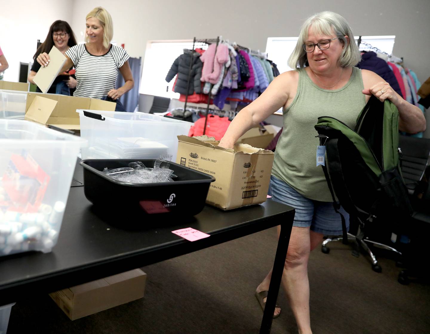 Big Hearts of Fox Valley volunteers (right to left) Darlene Riebe of St. Charles, Colleen Bittner of St. Charles and program chairperson Julie Garthwait fill backpacks with school supplies for students in St. Charles School District 303 as part of the organization’s back-to-school program in St. Charles.