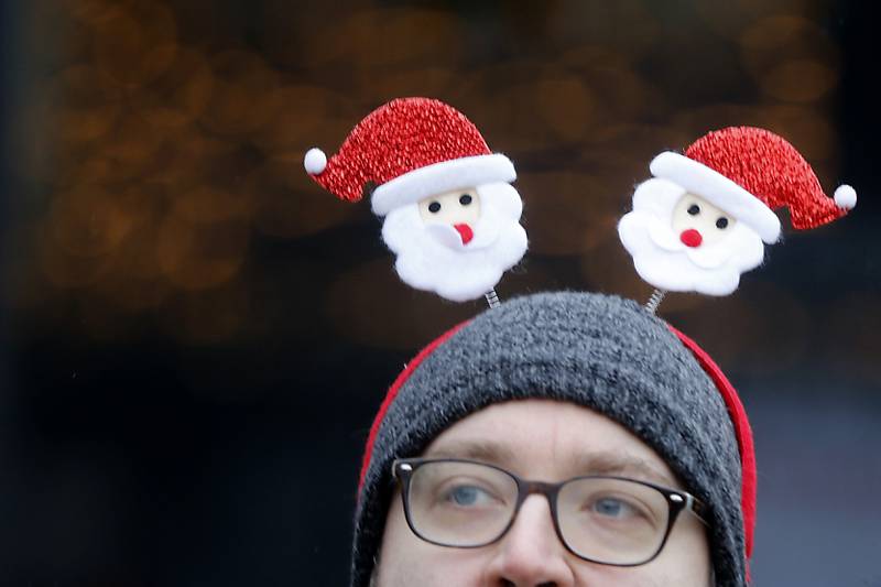 Gene Sowa looks for his mom, as he watches runners in the McHenry County Santa Run For Kids on Sunday morning, Dec. 3, 2023, in Downtown Crystal Lake. The annual event raises money for agencies in our county who work with children in need.