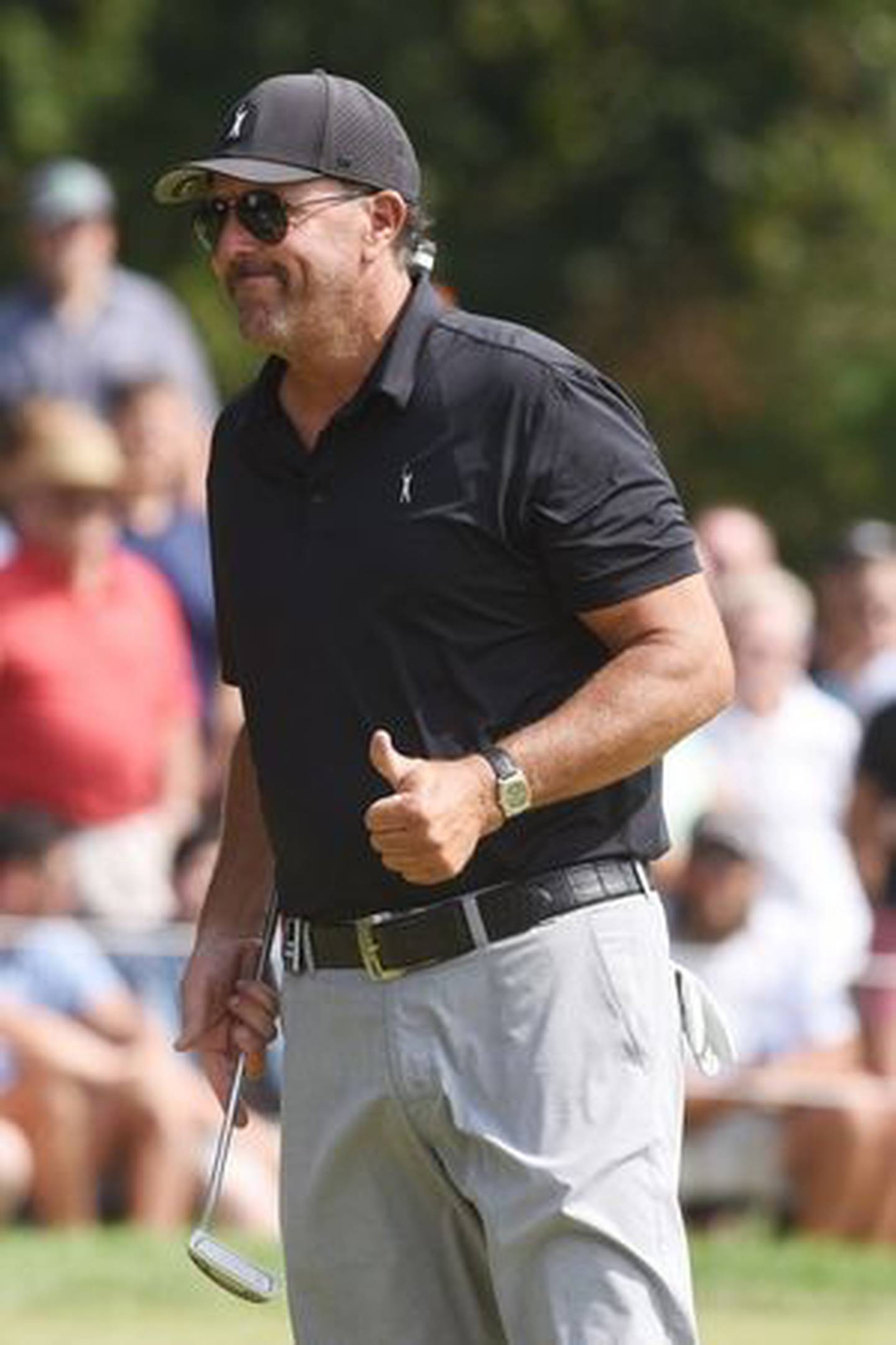 Phil Mickelson gives fans surrounding the 18th green a thumbs-up during the LIV Golf Invitational in Sugar Grove Saturday