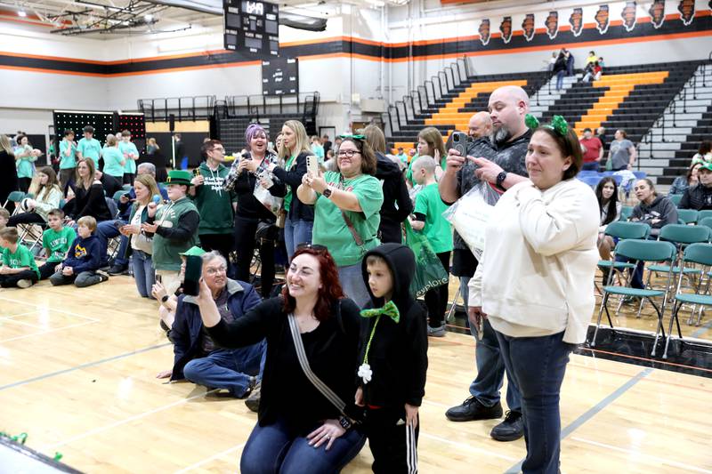 Onlookers photograph participants as they have their heads shaved during the St. Charles Challenge fundraiser for the St. Baldrick’s Foundation on Friday, March 15, 2024 at St. Charles East High School.