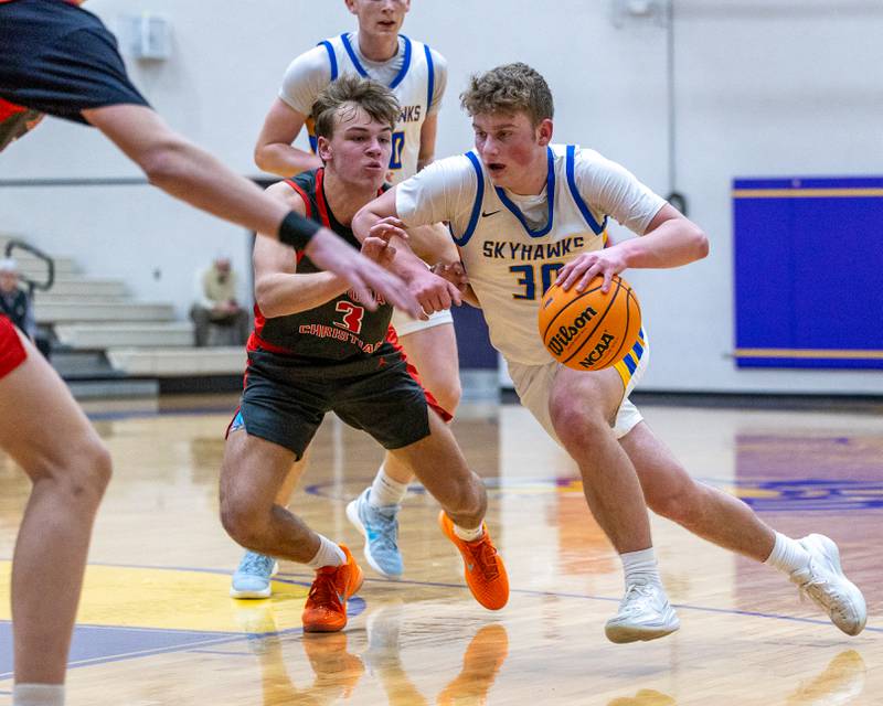 Jayce Schmitt (30) of Johnsburg drives ball down lane as Aurora Christian's Preston Morel (3) guards whilst reaching in during the Class 2A Boys Sectional Basketball tournament game on Wednesday, March 4, 2026 at Mendota High School.
