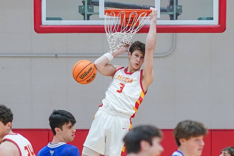 Batavia's Jax Abalos (3) dunks the ball off of a backdoor cut against Marmion during a basketball game at Batavia High School on Wednesday, Nov. 27, 2024.