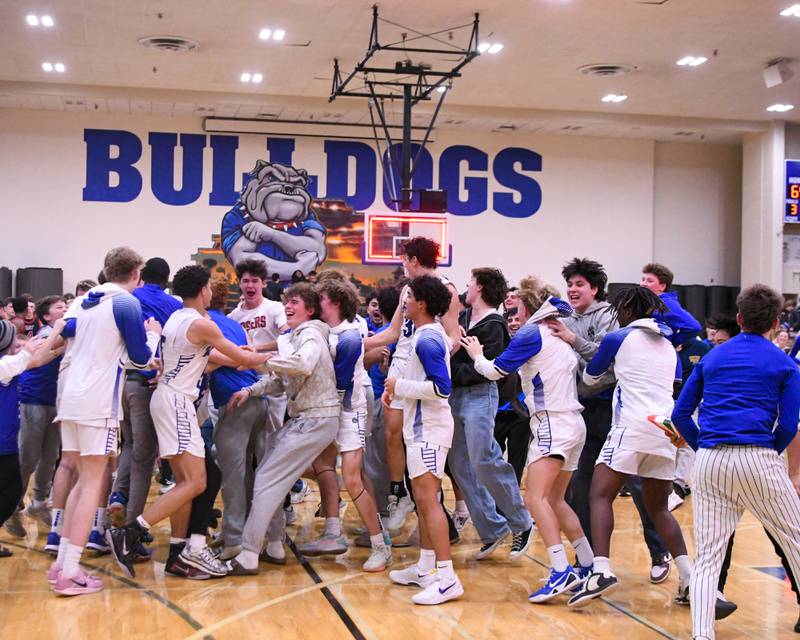 Riverside-Brookfield students storm the court after taking the win over Glenbard East on Tuesday Feb. 3, 2026, held at Riverside-Brookfield High School.