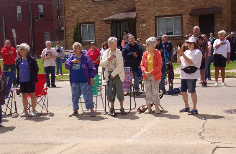 Attendees hold their hands to their heart during "The Star Spangled Banner" performed by the Streator High School Band on Monday, May 27, 2024, during the Memorial Day ceremony at Veterans Memorial Plaza in Streator's City Park.