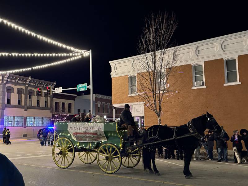 A horse-drawn carriage makes its way down Liberty St. during the Morris Home for the Holidays parade.