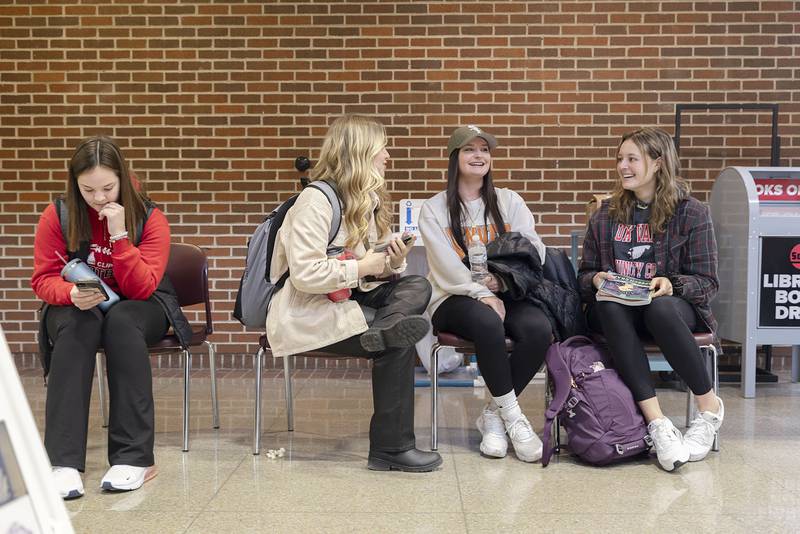 SVCC students Dana Merriman (left) of Amboy, Chloe Coil of Dixon, Meg Frank of Rock Falls and Ellenor Zimmerman of Dixon wait their turn in front of caricature artist Kevin Berg Tuesday, Jan. 17, 2023.