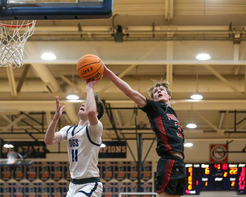Yorkville's Joey Jakstys (32) gets a piece of a shot attempt by Downers Grove South's Nathan Parker (11) during their Class 4A Naperville North Regional final basketball game between Yorkville at Downers Grove South, Feb 27, 2026 in Naperville.