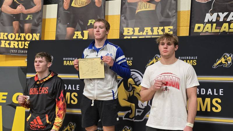 Newman's Daniel Kelly, center, is pictured after winning the 165-pound title at the Class 1A Riverdale Regional on Saturday, Feb. 8, 2025. Morrison's Brody Anderson, right, was the runner-up and Kewanee's Joey McGuire, left, took third.