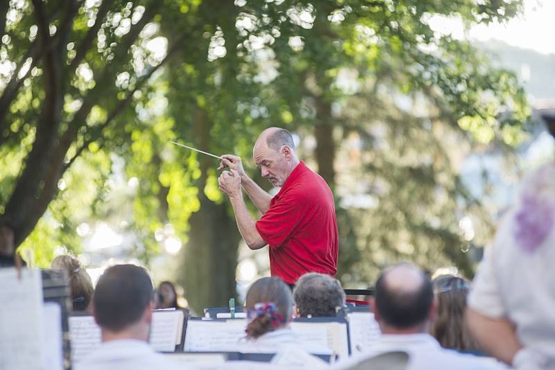 Dixon Municipal Band conductor Jon James leads his band Friday, July 1, 2022 as they perform on the old Lee County Courthouse lawn for their annual July 4th concert. The lawn was packed as the band played an assortment of patriotic themed songs.