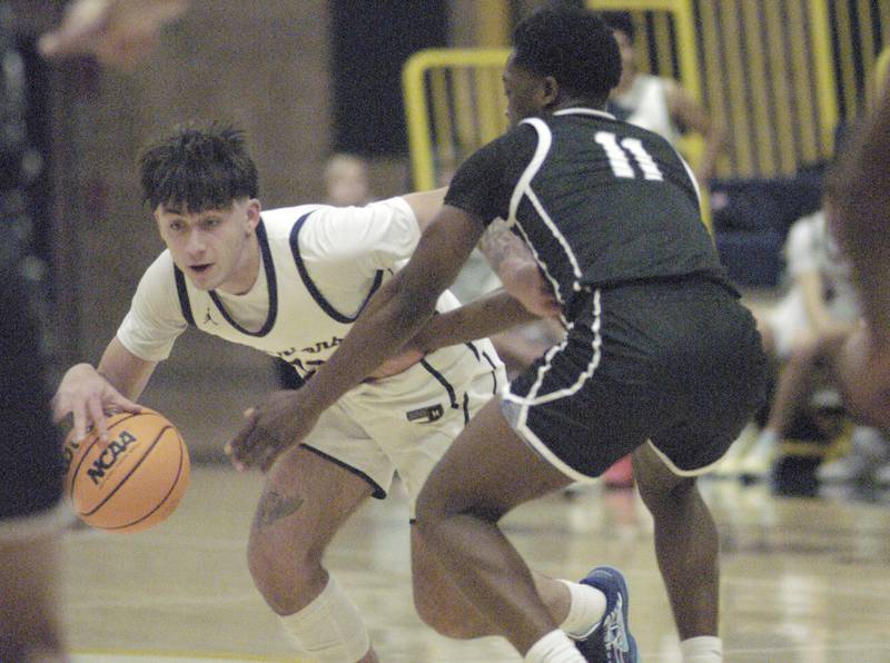 Sterling's Nico Battaglia drives the ball past Galegurg's Tobi Kivunina. Sterling Boys Basketball hosted Galesburg at Musgrove Fieldhouse on February 11, 2025.