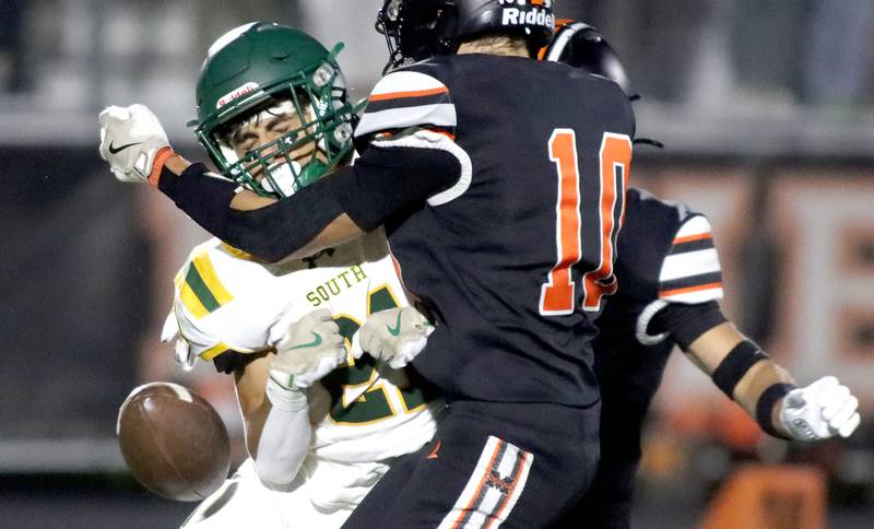 McHenry’s Owen Hobson, right, causes a fumble as the ball pops loose on a Crystal Lake South kickoff return in varsity boys football at McCracken Field on the campus of McHenry High School in McHenry on Friday, Sept. 5, 2025.